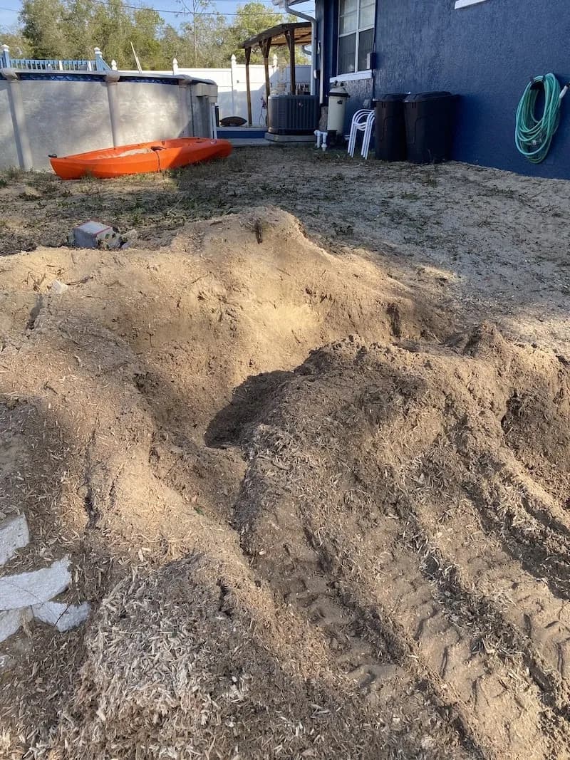 Same backyard after the stump was ground out, grindings left in place